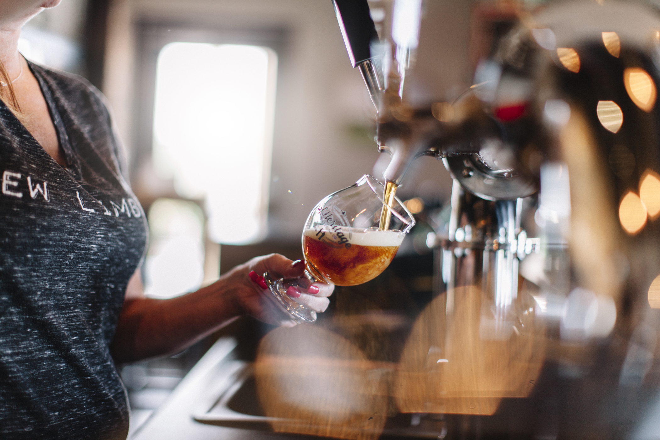 GL Heritage Brewing Co. taproom bartender pouring craft beer