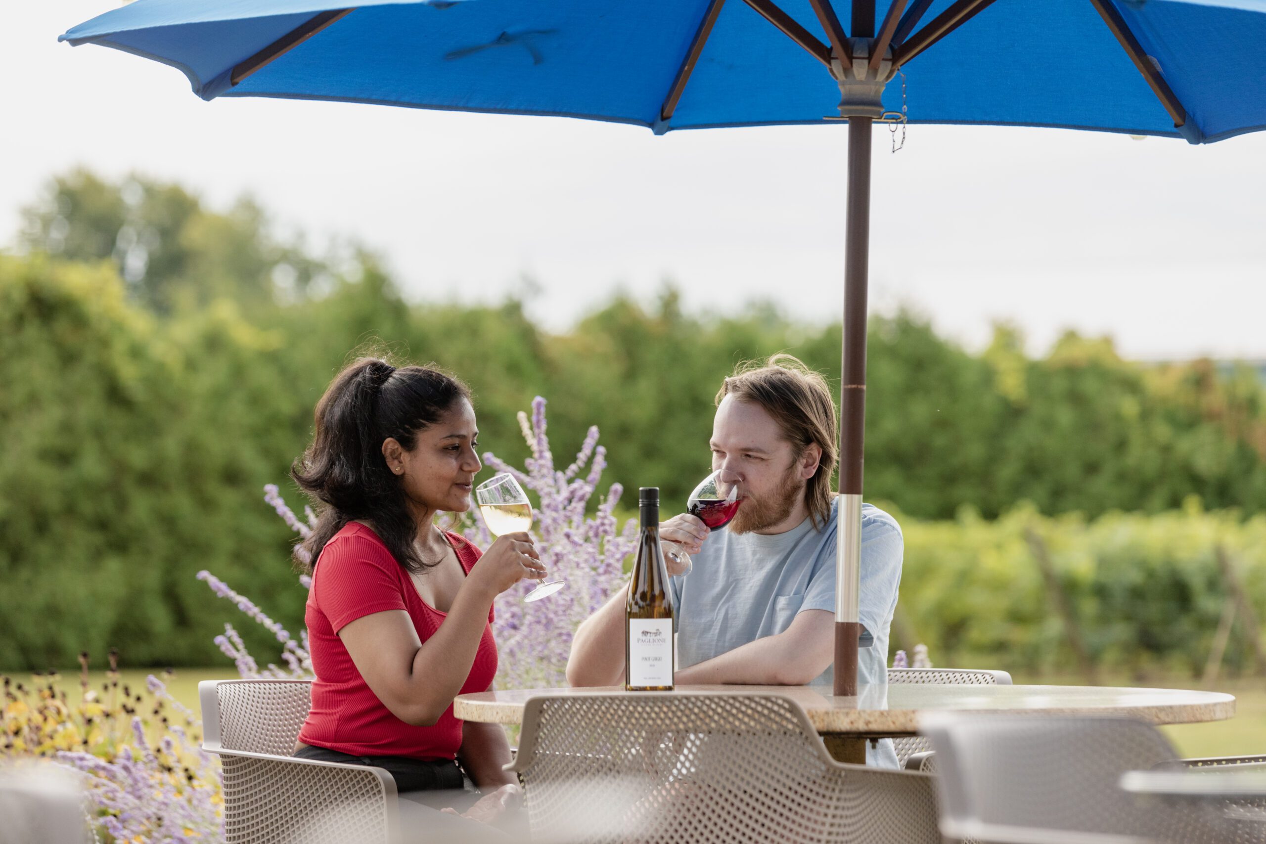 A couple sips on wine on the outdoor patio at Paglione Estate Winery