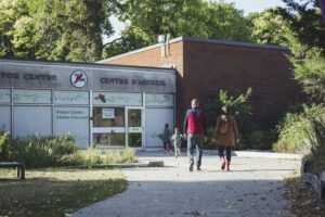 Family walking away from the visitor's centre at Point Pelee National Park.