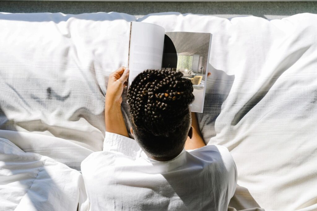 Woman reading outdoors  in a cozy robe 